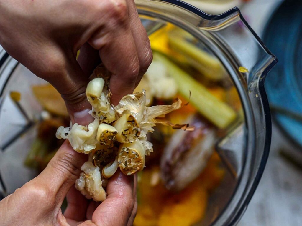 squeezing out roasted garlic